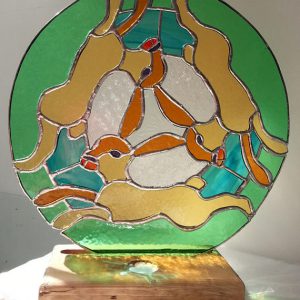 Three Hares Dancing Around the Moon (stained glass art)