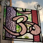 Om handmade stained glass panel in pink and confetti glass